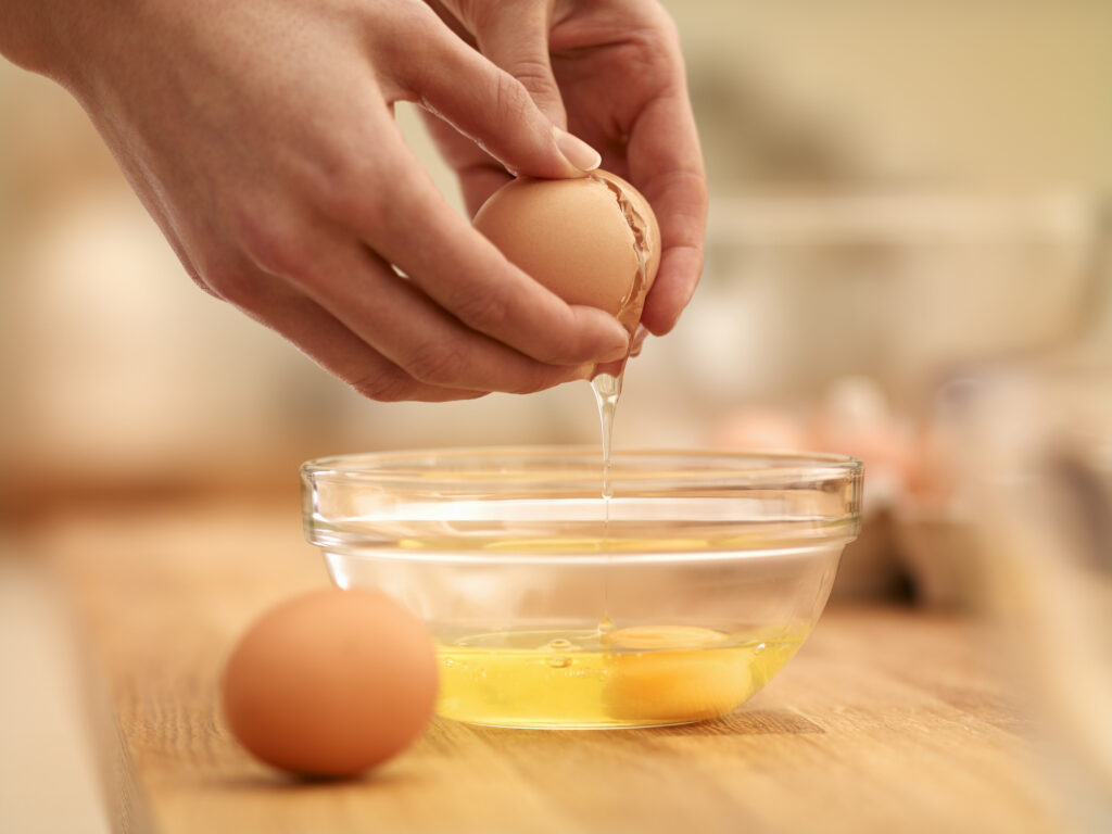 Woman cracking egg